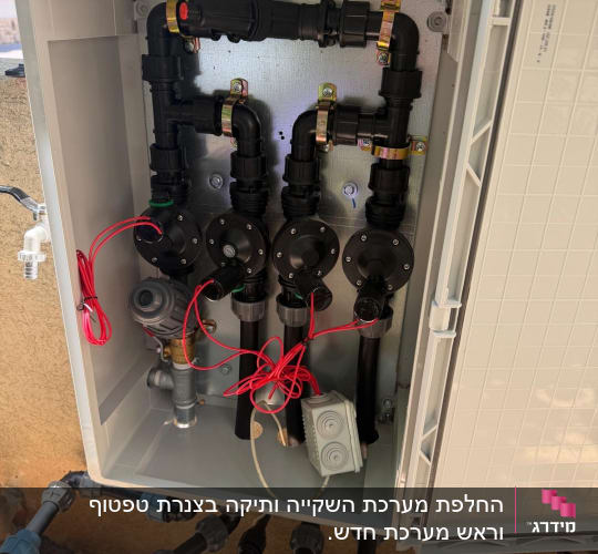 ארון מרכזיית השקיה עם ברזים חשמליים וצנרת בגינה